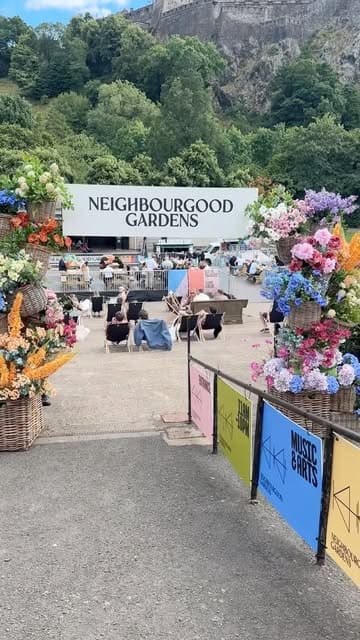 A short montage video showcasing the Neighbourgood Gardens pop-up venue in Edinburgh, featuring views of Edinburgh Castle, live music, and street food offerings like steak frites.