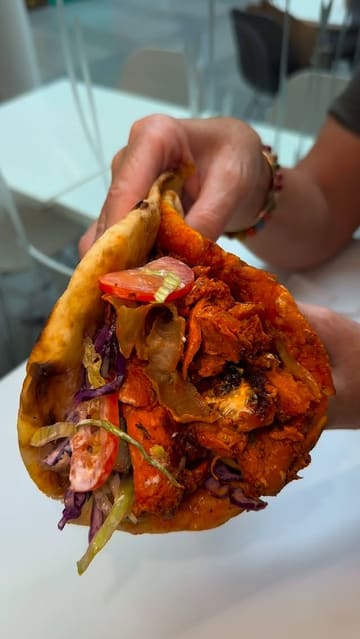 A montage showcasing the preparation and serving of fish and chips and kebabs at Tasty Plaice. The video features close-up shots of the food being prepared, dipped in sauces, and presented, focusing on the textures and portion sizes.