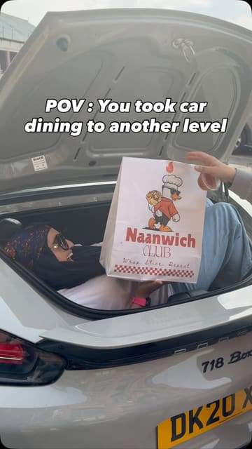 A high-energy, vlog-style reel showcasing a visit to Naanwich Club in Manchester, highlighting their viral butter chicken sauce, pizzas, naan wraps, and loaded fries, with a fun 'car dining' concept.