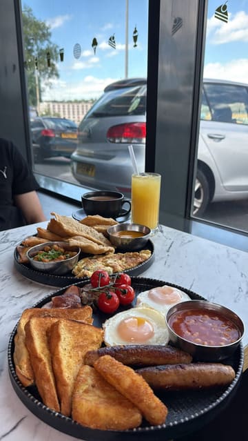 A promotional reel for a new cafe in Blackburn, showcasing a variety of breakfast options including a traditional English breakfast, a Desi breakfast, and French toast, alongside Indian street food snacks like samosas.