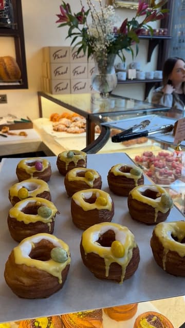 A promotional video for a new London bakery, Fred Bakery, showcasing their range of artisan pastries, coffee menu, and interior setting.