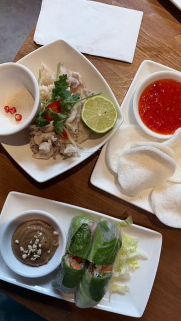 The creator visits a Vietnamese restaurant to highlight their extensive gluten-free menu. The video features a personal narrative about dining with coeliac disease, followed by a tour of the menu and a variety of dishes including summer rolls, baby squid, pho, and a pandan waffle.