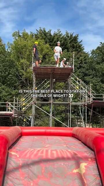 A fast-paced promotional reel for Lower Hyde Holiday Park on the Isle of Wight, featuring a montage of various activities including bungee trampolining, bubble football, swimming, dining, and cycling.
