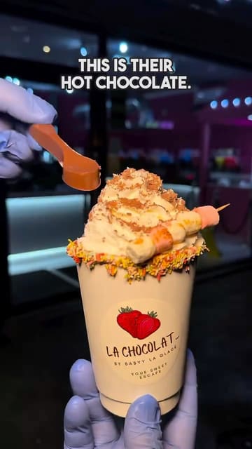 A high-quality, fast-paced video showcasing the preparation of various indulgent chocolate desserts and drinks at Baby La Glace, including hot chocolate, waffle bites, and candy apples.
