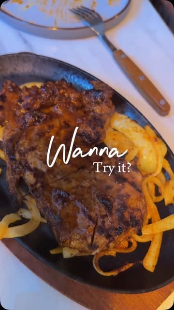 A promotional montage for Hunger Steaks, highlighting their sizzling steak dishes, grilled meats, cocktails, and the restaurant's interior decor.