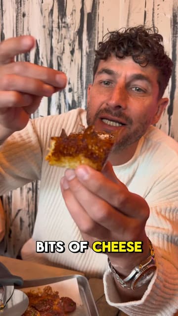 A creator visits Pop Kitchen in Exeter to review their viral Detroit-style pizzas and a Cuban sandwich. The video features close-ups of the food, highlighting the crispy cheese edges, and includes the creator's enthusiastic commentary on the quality of the food and the independent nature of the venue.