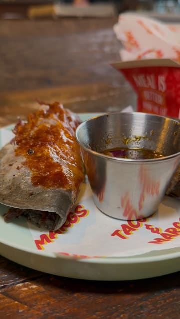 The creator visits Picante in Cains Brewery Village, Liverpool, to review their latest menu offerings. The video features a tour of the venue, close-ups of various tacos (beef birria, coconut shrimp, chicken) and wings, and the creator's enthusiastic taste test reactions.