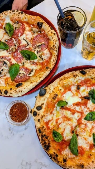 A short, energetic promotional reel for Spaccanapoli in Glasgow, showcasing their Neapolitan pizzas, the restaurant exterior, and the pizza-making process.