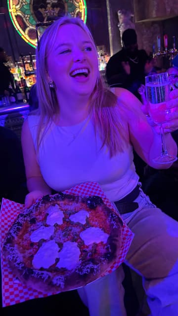 A lively, handheld-style reel capturing a group of friends enjoying a 'Slow Jams' themed bottomless brunch at The Old Queens Head. The video features shots of the venue's interior, the pizza served, cocktails, and the energetic atmosphere with a host and music.