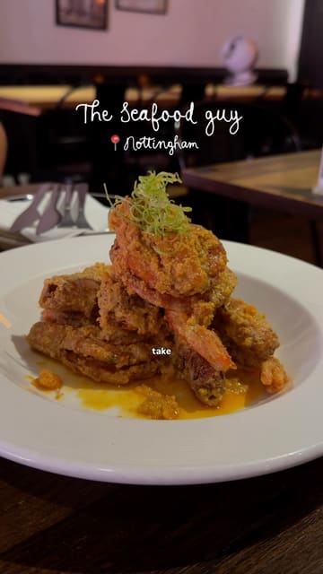 A creator visits 'The Seafood Guy' in Nottingham, a Hong Kong-style cafe, showcasing the interior and various dishes including seafood, french toast, and bao buns.