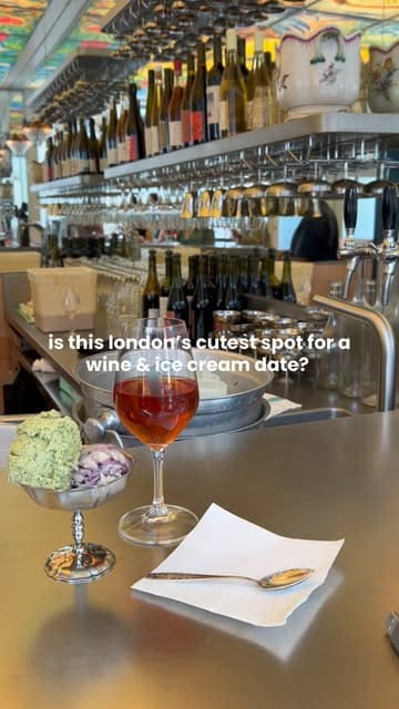 A short, aesthetic montage showcasing a wine and ice cream venue in Islington, featuring shots of the colorful interior, wine glasses, and scoops of ice cream.