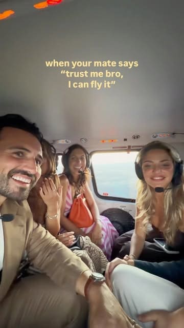 A short, energetic video featuring a group of friends enjoying a helicopter flight. The video uses a humorous text overlay to frame the experience as a fun, adventurous outing.