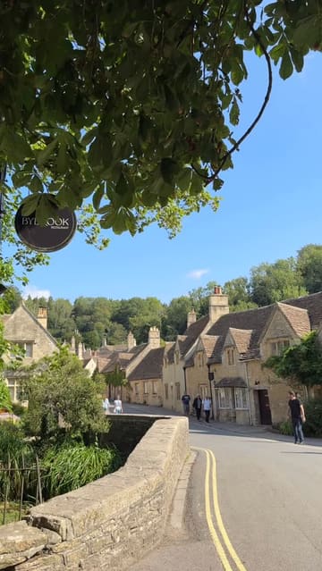 A travel vlog documenting a day trip from London to three picturesque locations: Lacock, Castle Combe, and Bradford-on-Avon. The video features the creator visiting historic sites, walking through scenic villages, and enjoying a Sunday roast at a pub.