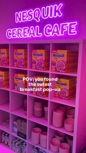 A short, bright promotional video showcasing a Nesquik strawberry cereal pop-up in Covent Garden. The video features the neon-lit interior, the menu options, and the cereal bowls, highlighting the family-friendly nature of the event.
