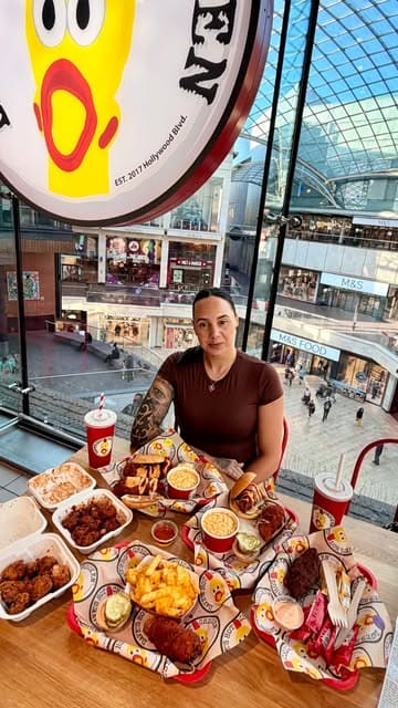 A couple visits Dave's Hot Chicken in Bristol to review their menu, including a spicy food challenge with the 'Reaper' level chicken.