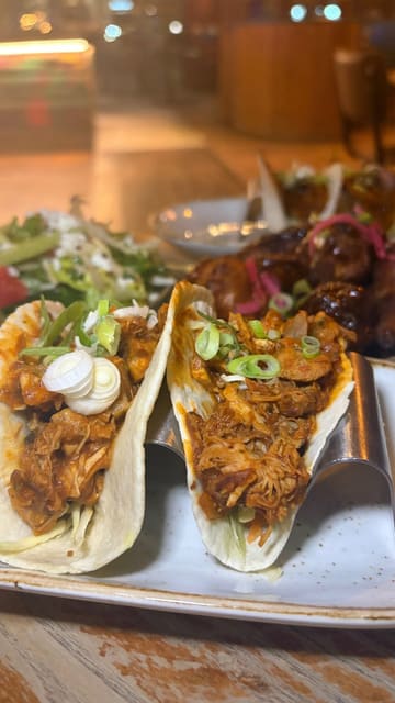 A montage-style reel showcasing the interior, cocktails, and various tapas dishes at a Las Iguanas restaurant. The video highlights the variety of food available through the bottomless tapas menu.