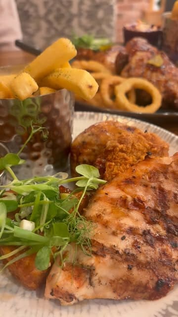 A video showcasing a visit to a Harvester restaurant, highlighting the salad bar and various main courses including mixed grills and chicken dishes.