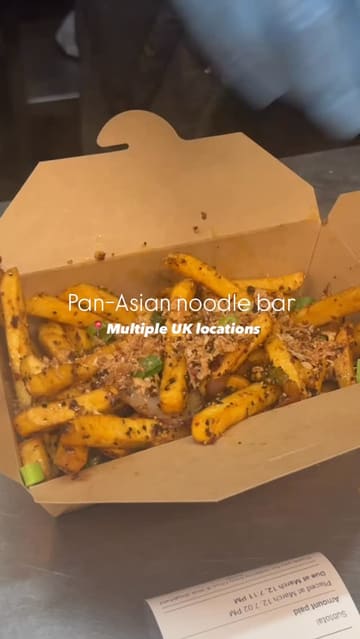 A review of Chop and Wok, showcasing their noodle dishes, salt and pepper fries, and prawn crackers. The video includes shots of the cooking process, the menu, and the final takeaway meals.