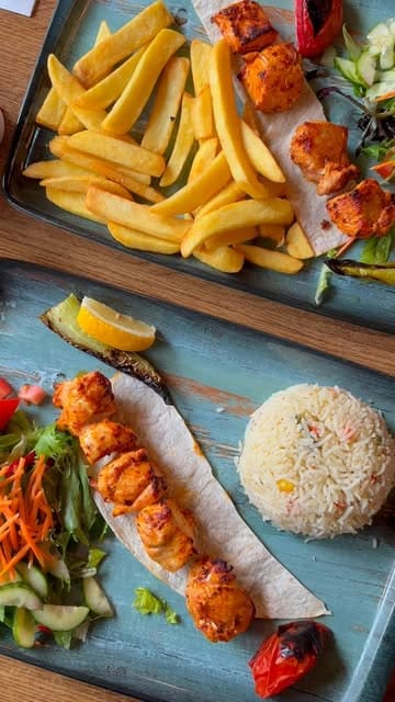 A montage of shots showcasing the interior decor and various Turkish dishes including meze, kebabs, and sides at The Kervan Restaurant.