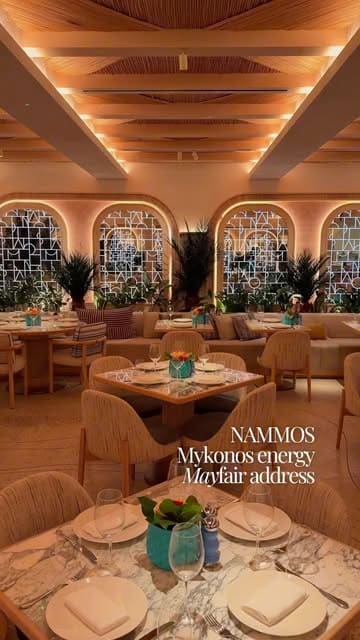 A polished, aesthetic showcase of Nammos London, highlighting the upscale interior design and high-end food presentation.