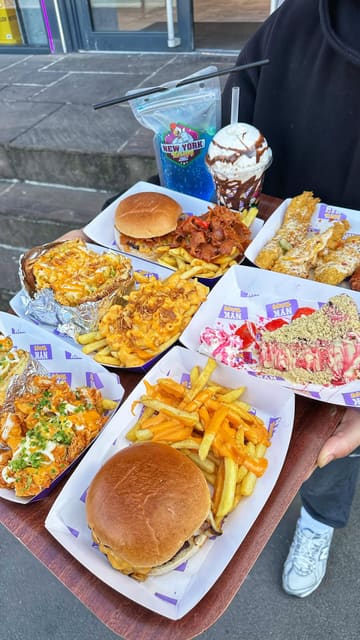 A fast-paced, enthusiastic review of a fried chicken shop in Bradford. The creator walks the viewer through the new menu, showcasing a variety of items including burgers, loaded fries, chicken tenders, wings, cheesecake, and milkshakes, while providing price points and taste impressions.