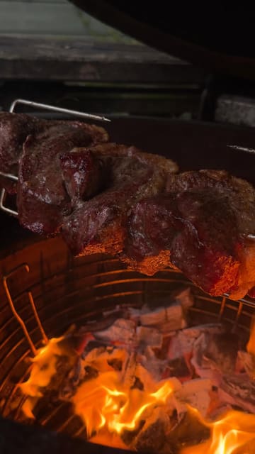 A first-person POV cooking video demonstrating the preparation and rotisserie cooking of a dry-aged Picanha steak from a local butcher.