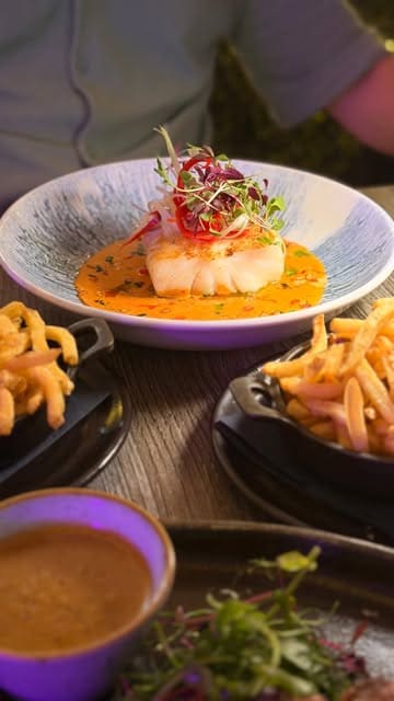 A montage video showcasing the interior, menu, and various dishes at The Brook Bistro, including steak, fish, and dessert, highlighting its suitability for families and date nights.