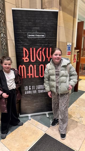 A personal vlog documenting a family day out in Hamilton, featuring a theatre performance of 'Bugsy Malone' at the Town House and a meal at the Japanese restaurant Salt. The video follows the children throughout their day, showing clips of the theatre, the restaurant interior, and the food they ordered.