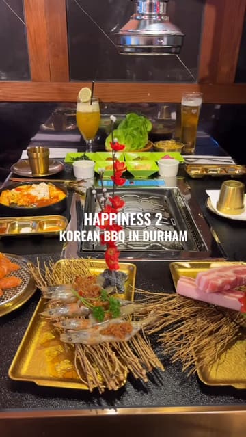 A fast-paced montage showcasing a Korean BBQ dining experience at Happiness 2 in Durham, featuring close-ups of raw and cooked meats like Wagyu short rib and pork belly, the table-side grilling process, and accompanying drinks.