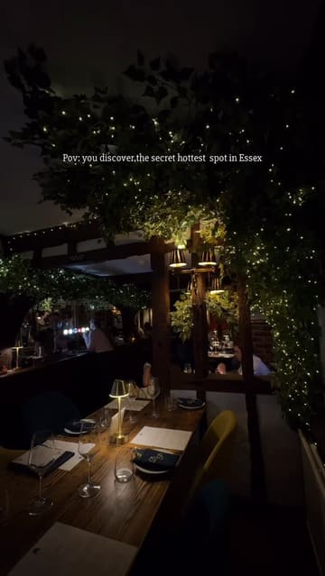 A polished montage showcasing the interior and food offerings of a restaurant, featuring dishes like scallops, beef wellington, and bread, set in a cozy, atmospheric environment with fairy lights.