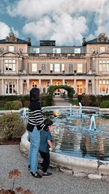 A montage video showcasing a family staycation at Down Hall, featuring shots of the hotel exterior, gardens, lobby, hotel room, and a dinner spread.