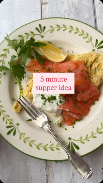 A short, instructional video demonstrating how to prepare a simple chive omelette topped with smoked salmon, sour cream, and a squeeze of lemon, presented as a quick supper idea.