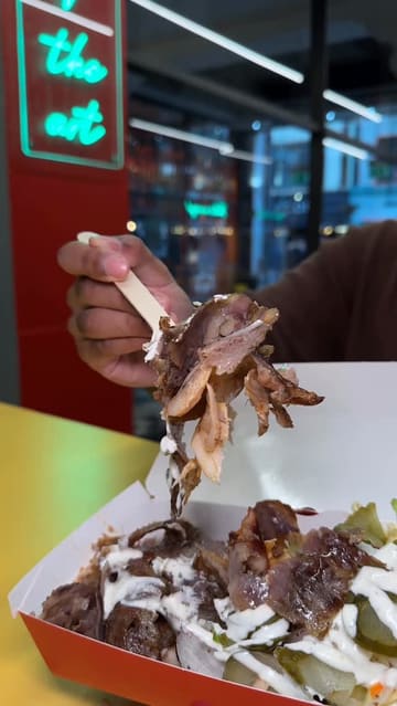 A short video showcasing a kebab shop that uses robotic slicing technology. It features close-ups of the meat being sliced by the machine, the preparation of a wrap, and a unique chocolate doner crepe dessert.