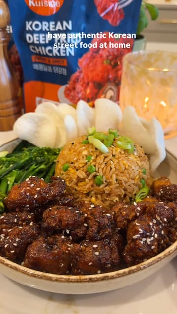 A short, fast-paced video demonstrating how to prepare a 'fakeaway' meal at home using Kuisine brand Korean deep-fried chicken, served with fried rice and prawn crackers.