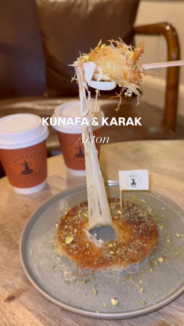 A short, music-led montage showcasing a dessert and tea shop, featuring close-ups of kunafa with a cheese pull, brownies, strawberry cups, and karak tea.