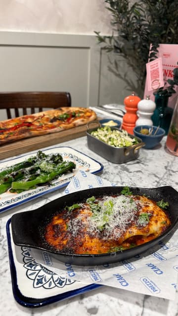 A promotional video showcasing a visit to a Prezzo Italian restaurant, highlighting various dishes including pasta-based arancini, burrata, lasagne, and pizza, alongside the venue's refurbished interior.