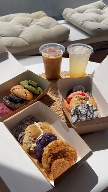 A short, friendly video showcasing a variety of cookies at a bakery, featuring the staff and the product display.