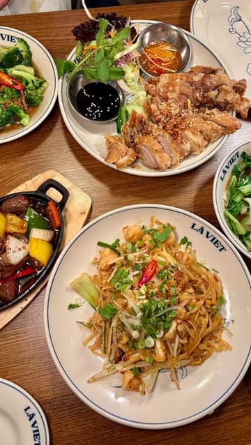 A vibrant and engaging review of La Viet in Edinburgh, showcasing the restaurant's cosy interior and a variety of authentic Vietnamese dishes including spring rolls, shaking beef, and crispy roast duck.