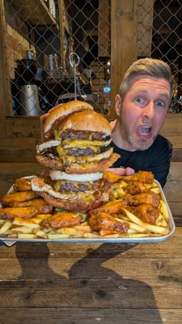 The creator visits Craft Burger in Oxford to attempt the 'Gutbuster 2.0' food challenge, documenting the process and comparing their performance against a previous record holder.