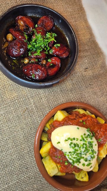 A promotional video for a Spanish tapas night at Springfield Events Hall, featuring shots of the venue's interior, table settings, and a variety of tapas dishes including patatas bravas, chorizo, meatballs, and sangria.