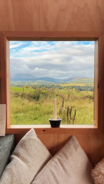 A montage of a couple's stay in a scenic cabin, featuring shots of the interior, the surrounding nature, a hot tub, a fire pit, and a cocktail.