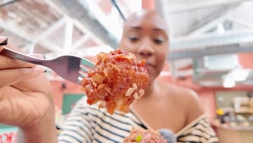 The creator visits two food halls in Birmingham, Art Quarter and Alfred Works, sampling various dishes including noodles, fried chicken, and a sandwich.