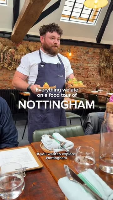 A vlog-style food tour of Nottingham, visiting five different local venues including a bakery, cheese shop, wine cellar, restaurant, and tea house, showcasing the food, drink, and history of the city.