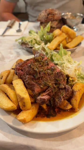 A short promotional video for Stockbridge Eating House featuring a selection of dishes including squid, steak, and a burger, while highlighting the use of the Shuffle Rewards app for cashback.