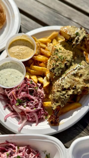A short, punchy review of a piri-piri chicken street food vendor, featuring close-ups of the cooking process, the finished dishes, and the creator tasting the food.