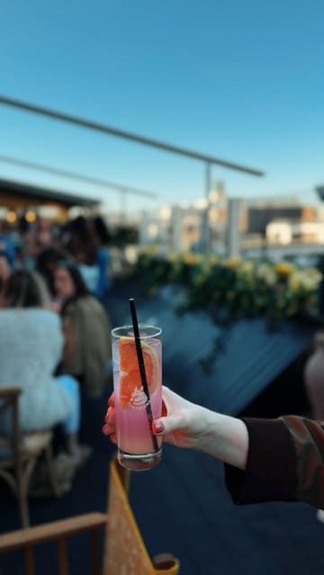 A promotional reel showcasing the reopening of a rooftop bar and restaurant, featuring small plates, cocktails, a DJ, and a lively atmosphere.