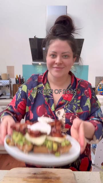 A home cooking tutorial demonstrating how to assemble a large breakfast stack featuring sourdough, homemade guacamole, halloumi, bacon, and poached eggs.
