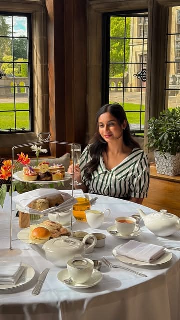 A visually appealing reel showcasing an afternoon tea service at Fanhams Hall, featuring close-ups of pastries, scones, and the elegant manor house interior.