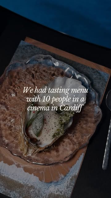 A couple reviews an immersive tasting menu experience called 'Source: Sea to Land' held inside a 360-degree cinema dome in Cardiff, featuring food by Hiraeth Kitchen.