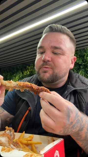 A creator reviews a takeaway venue called Caledonia Chicken and Ribs, comparing it to a previous bad experience at a different location. He samples the chips, ribs, and chicken, providing a positive review of the food quality and value.